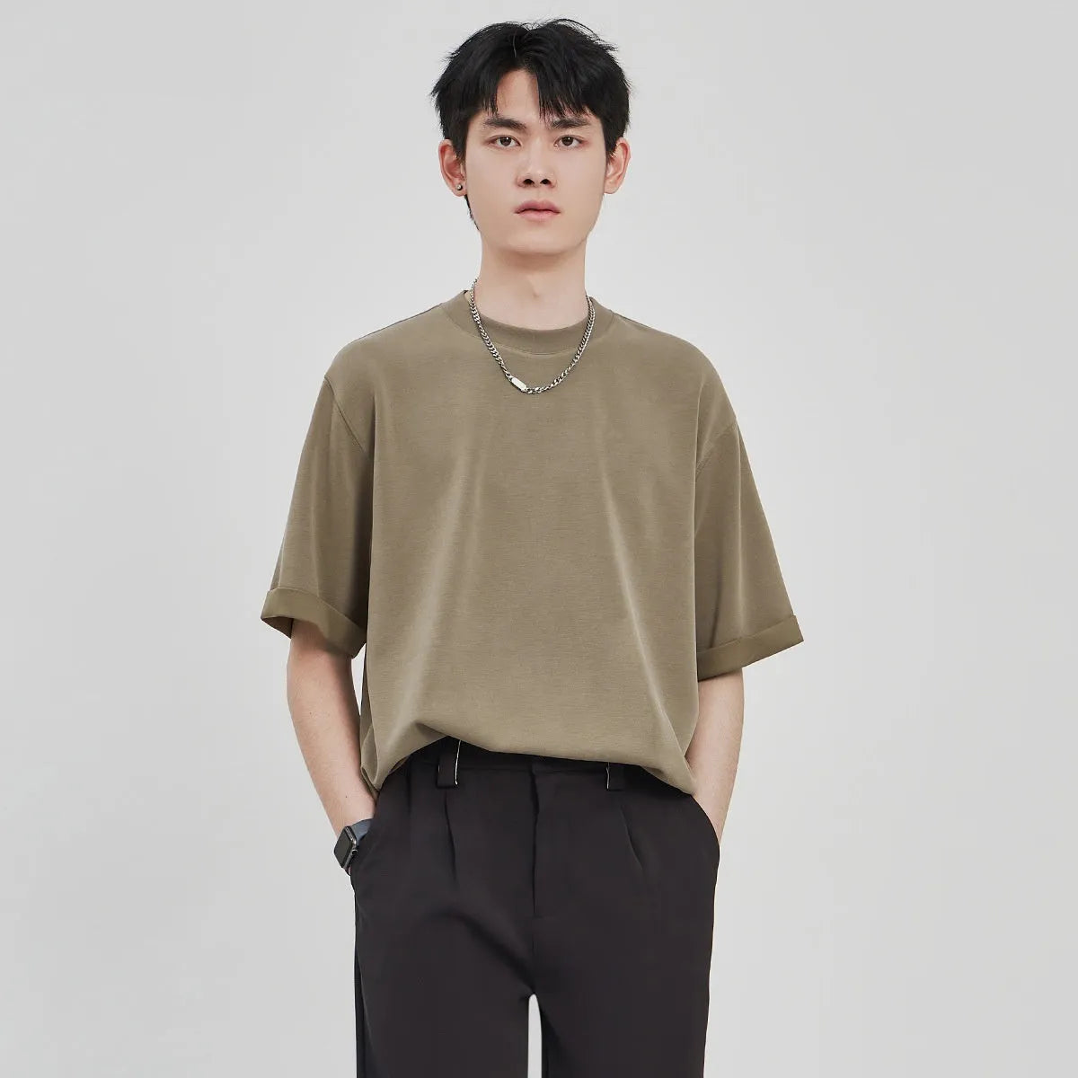 Men's brown drape knit loose t-shirt with short sleeves on a hanger.