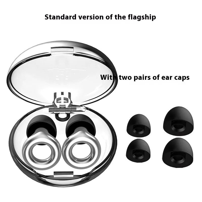 Set of gold-coloured noise reduction earplugs with a storage box and spare ear caps on a white background.