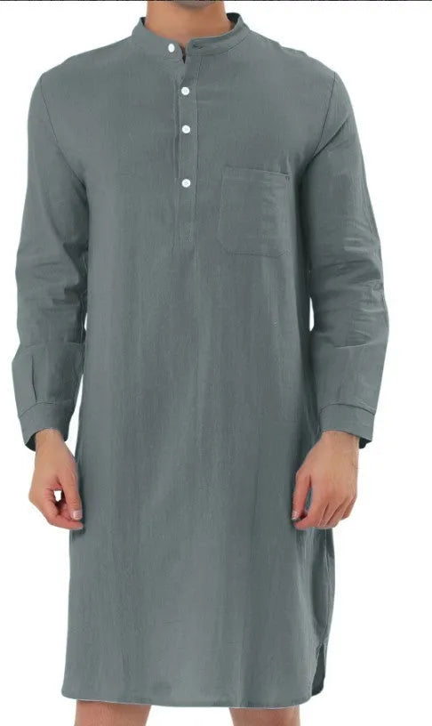 Man wearing a dark blue cotton shirt robe with button front, long sleeves, and side pockets.