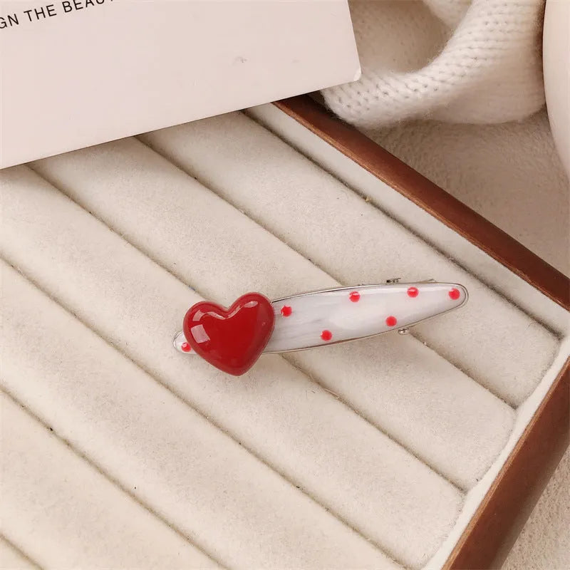 Red love heart-shaped hair barrette clip with retro white dots on a willow leaf-shaped base.