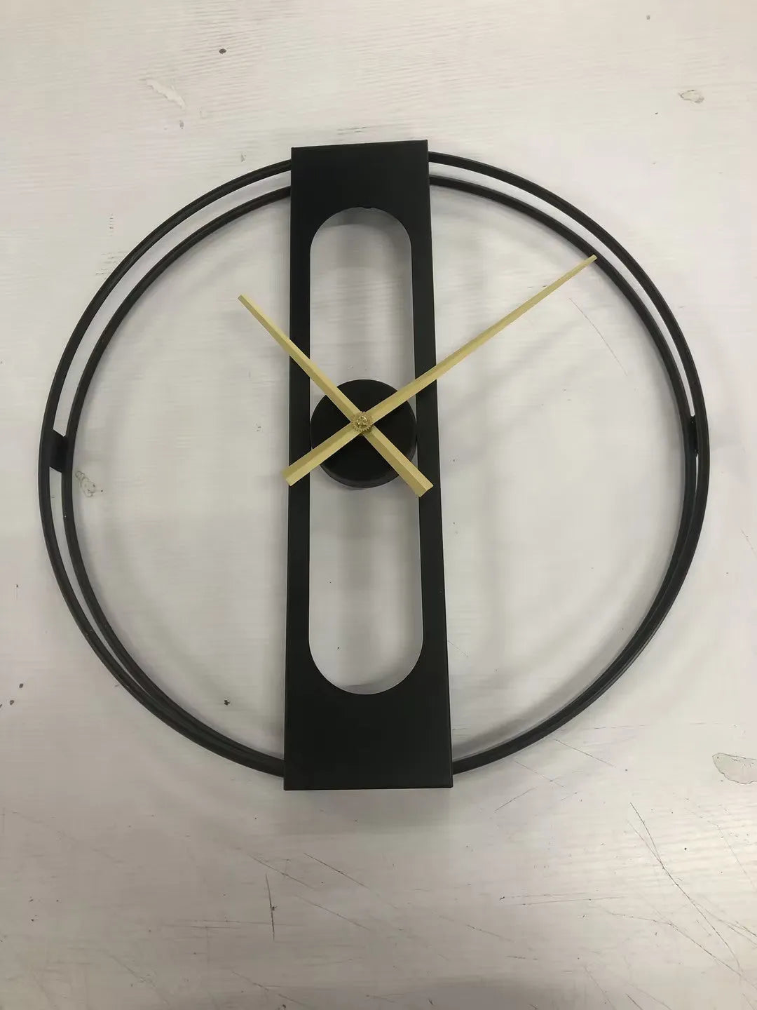 Large round metal wall clock with black finish showing analogue dial, 50cm in diameter.