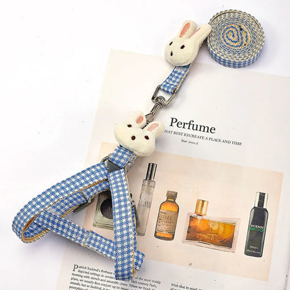 Blue quick-release nylon dog harness and leash set for small pets on a white background.
