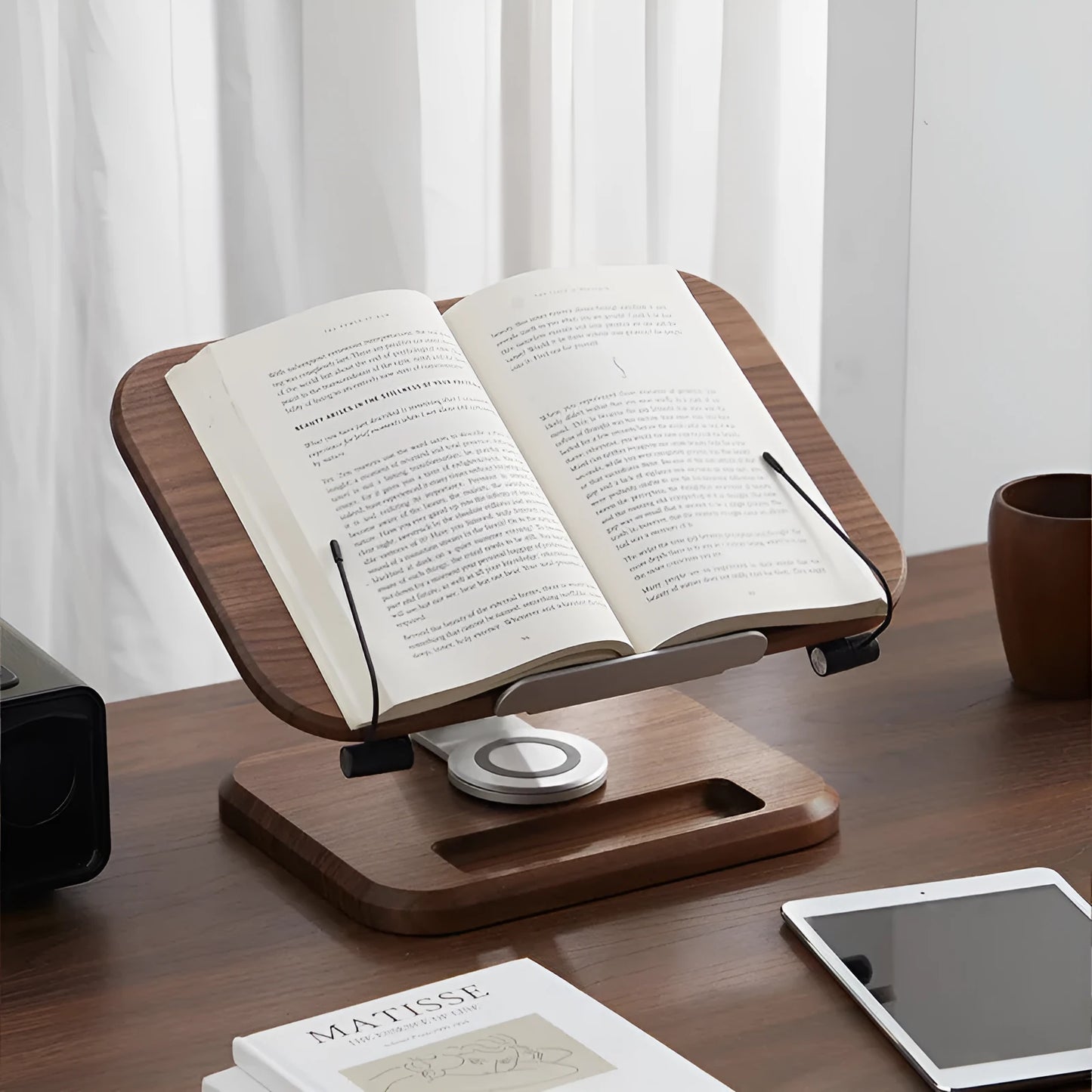 Walnut coloured solid wood adjustable reading rack with rotating base holding a book