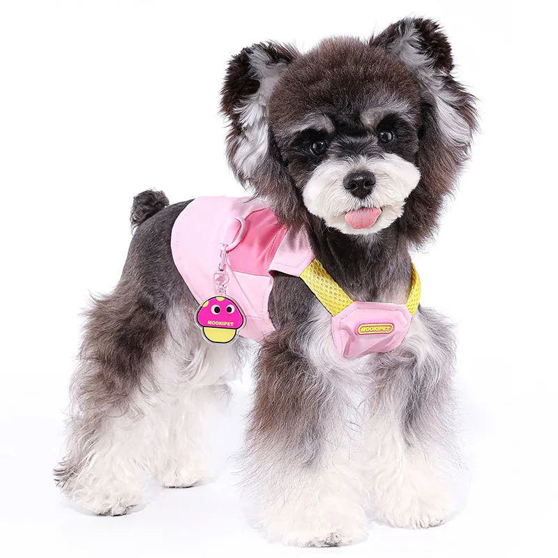 Pink polyester dog vest harness on a small white dog, showing back traction loop and casual fit.
