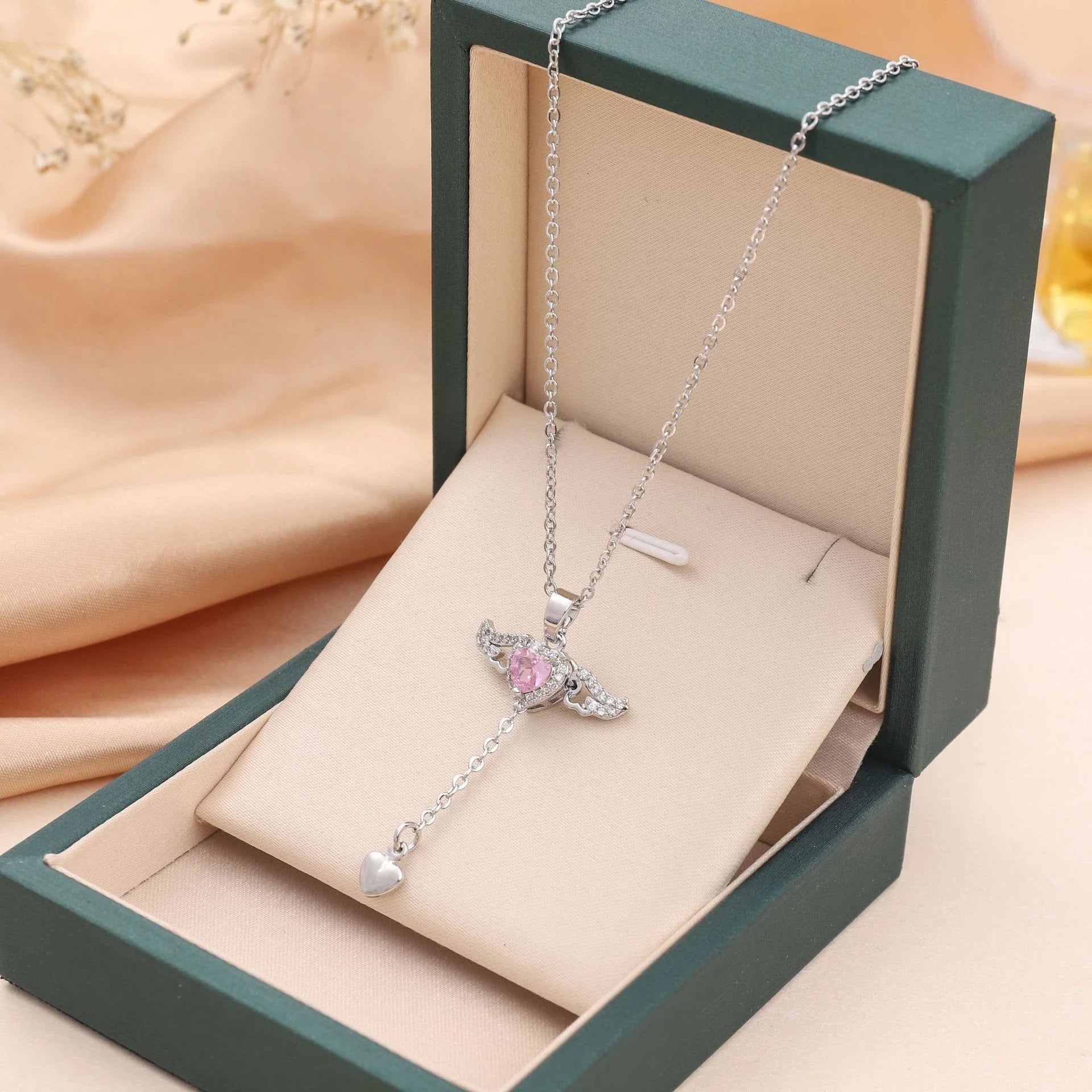 Elegant angel wings necklace with moving heart pendant, made of titanium steel and crystal accents