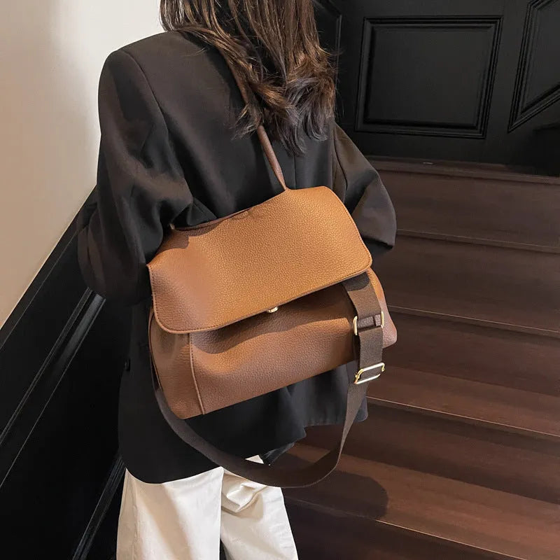 Horizontal square tote bag constructed from PU leather with double shoulder straps, featuring sewing thread decorative elements, available in beige, black, brown, coffee and khaki colours for versatile daily use.
