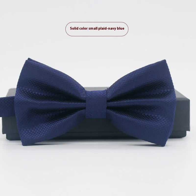 A solid colour pre-tied bow tie with an adjustable neck strap, shown in a classic flat head shape.