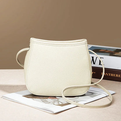 Women's genuine cowhide leather messenger bag showing organisational compartments and sandwich pockets in neutral colour
