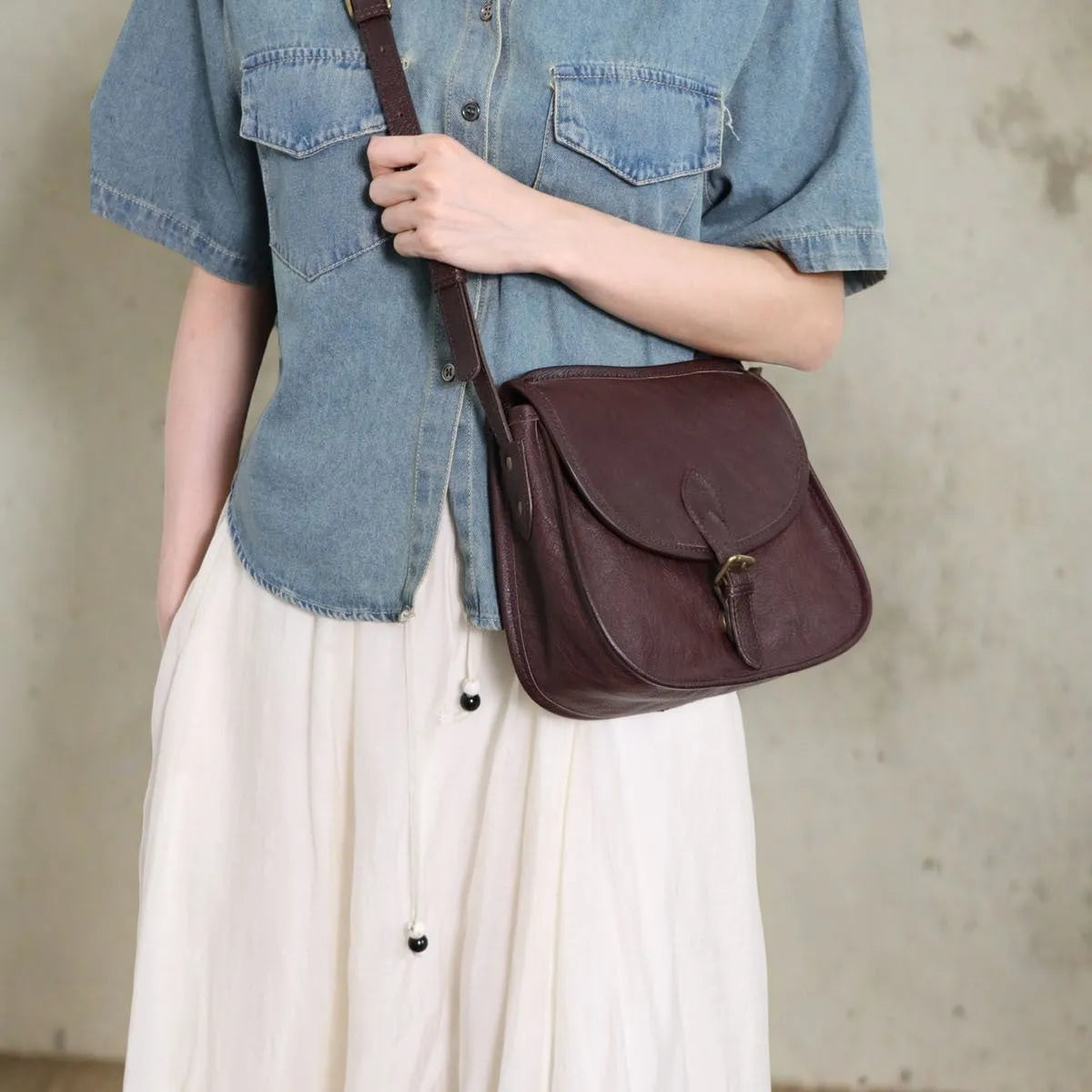 Genuine leather retro messenger bag with crossbody strap and flap closure in coffee colour