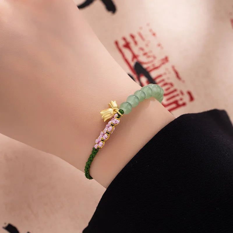 Red rope hand woven bracelet with floral design and Lily carrying strap colour
