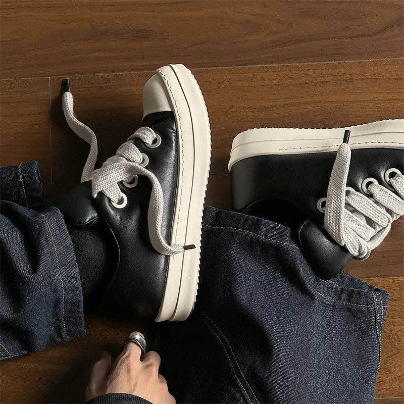 Black men's slip-on casual shoes with leather upper, rubber sole, and raised platform design