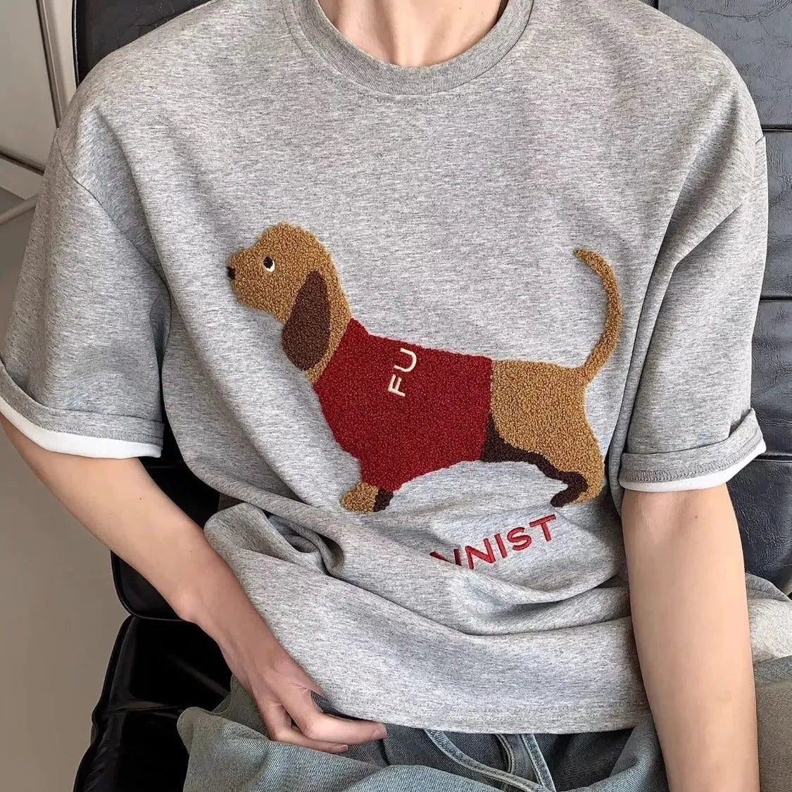 Men's black cotton T-shirt with embroidered sausage dog wrapped in a towel design
