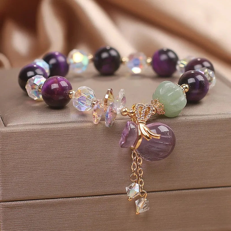 Women's crystal bracelet with purple tigereye money bag pendant and rhinestone decorations