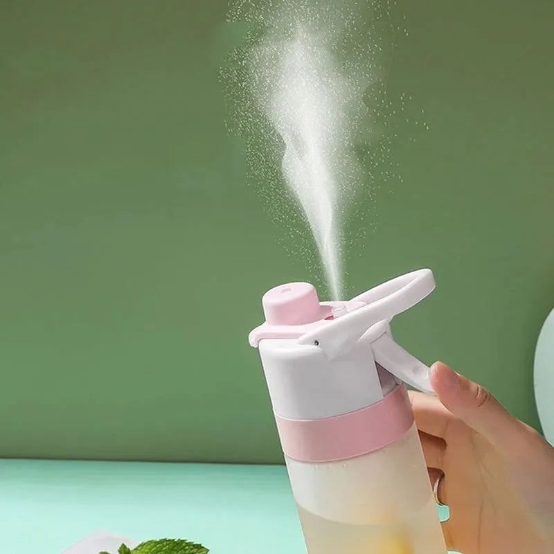 White spray water bottle with black leakproof lid and handle strap on a table