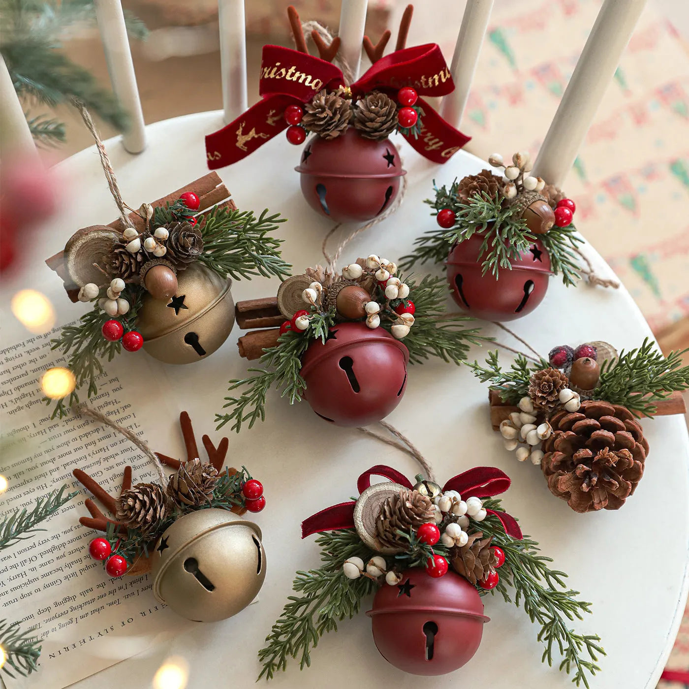 Wrought iron decorative pendant with antlers, pine cone, bowknot, and a small bell in a choice of colours.