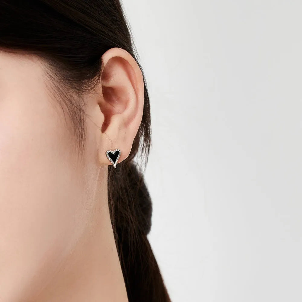 S925 silver heart-shaped stud earrings with black agate and white stone in a cold wind style, one pair