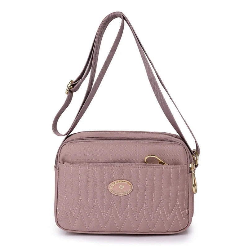 Compact nylon messenger bag for women in various colours with adjustable strap