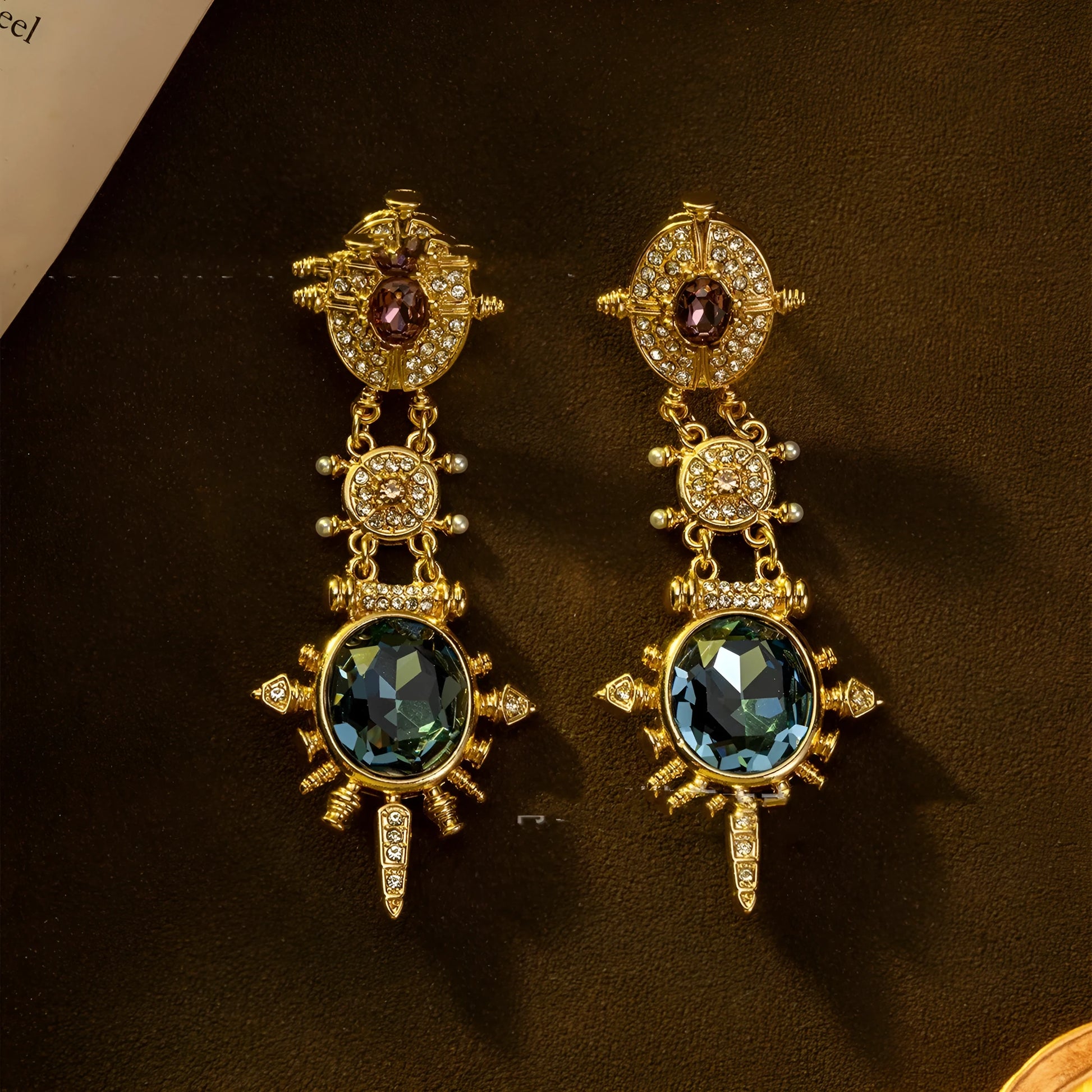 A pair of gold-coloured geometric stud earrings with round details and a retro style.