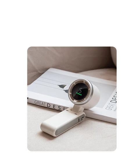 Portable folding mini fan showing adjustable head and compact plastic housing with USB Type-C charging port