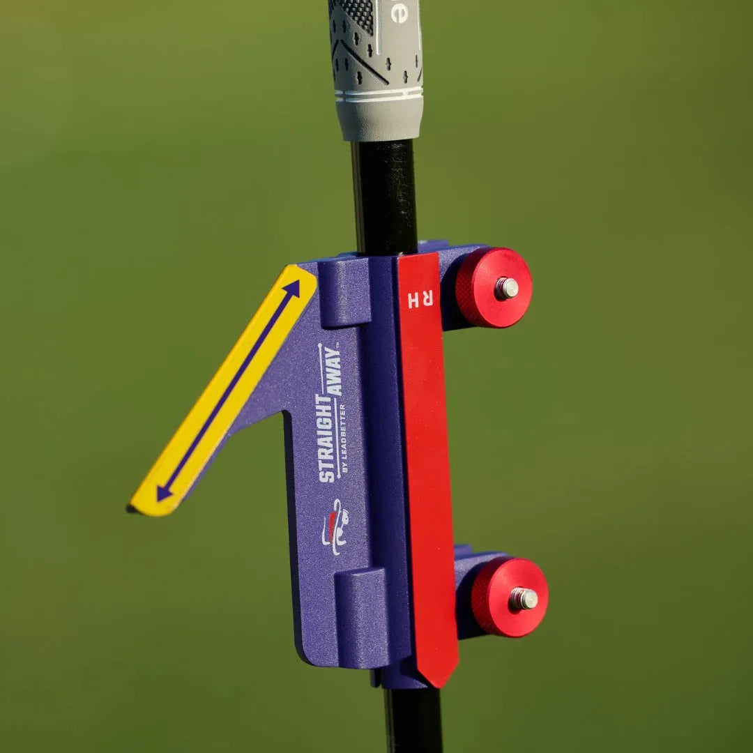 Plastic golf swing plane simulator training aid on a practice mat.