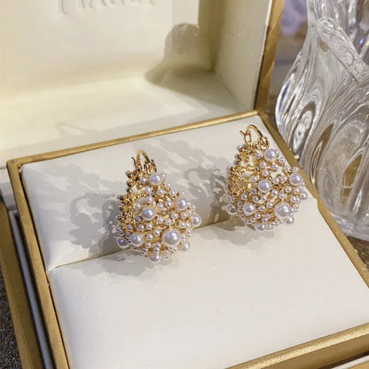 Gold-coloured women's floral basket earrings made from copper with small bead and pearl inlay detail.
