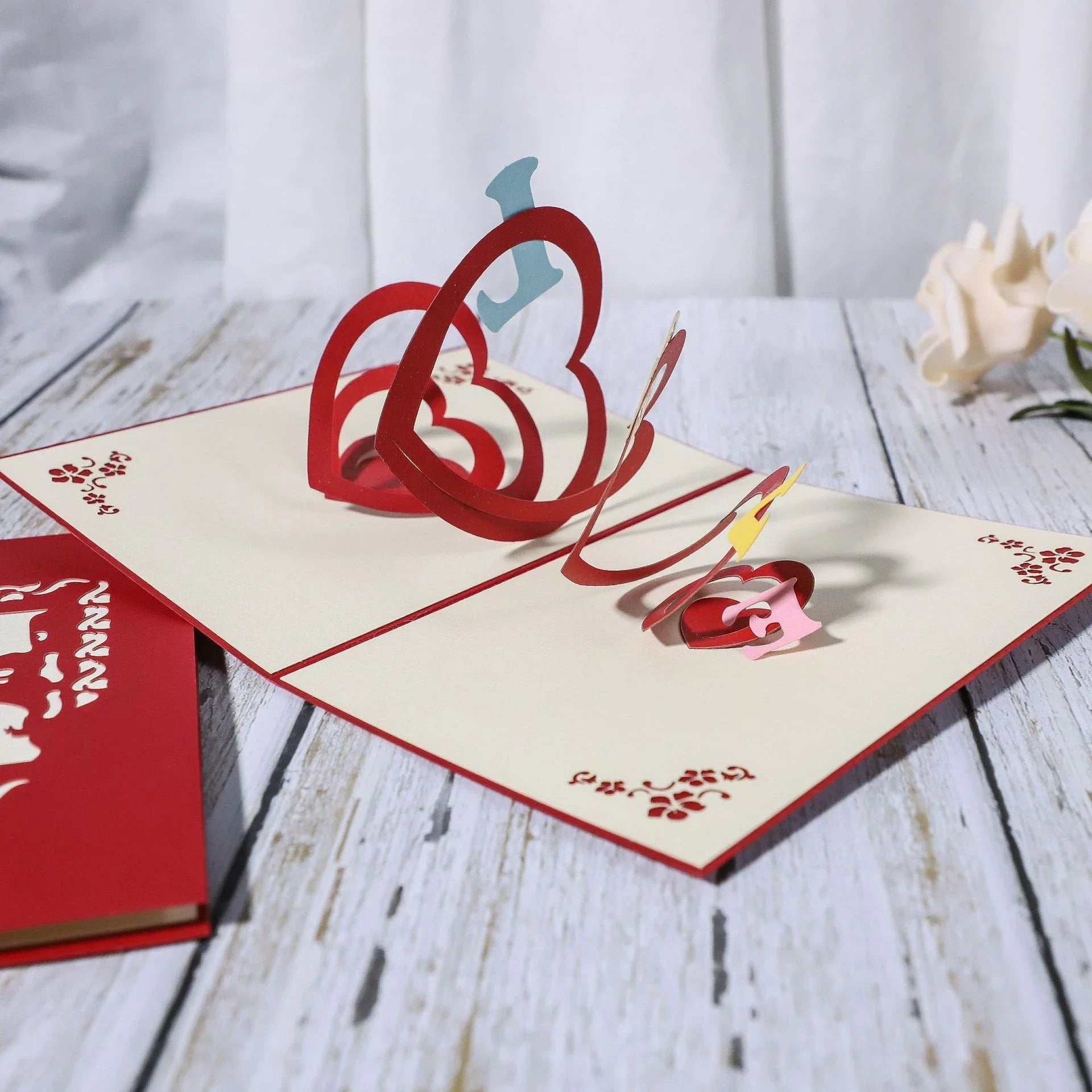 Exquisite 3D pop-up greeting cards for lovers, featuring a variety of romantic motifs like roses, landscapes, and couples.