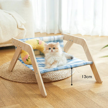 Elevated wooden cat beach chair bed with cloth lounging surface in blue or green.