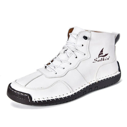 A pair of beige high-top casual boots with elastic band fastening and a flat rubber sole.