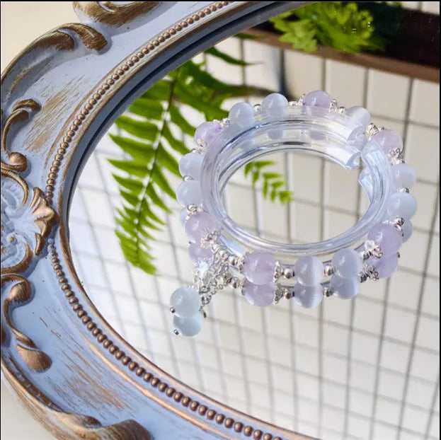 Moon-shaped women's bracelet with large opal amethyst crystal beads on wrist.