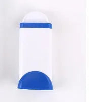 Blue reusable pet hair removal brush with double-sided head next to its self-cleaning base.