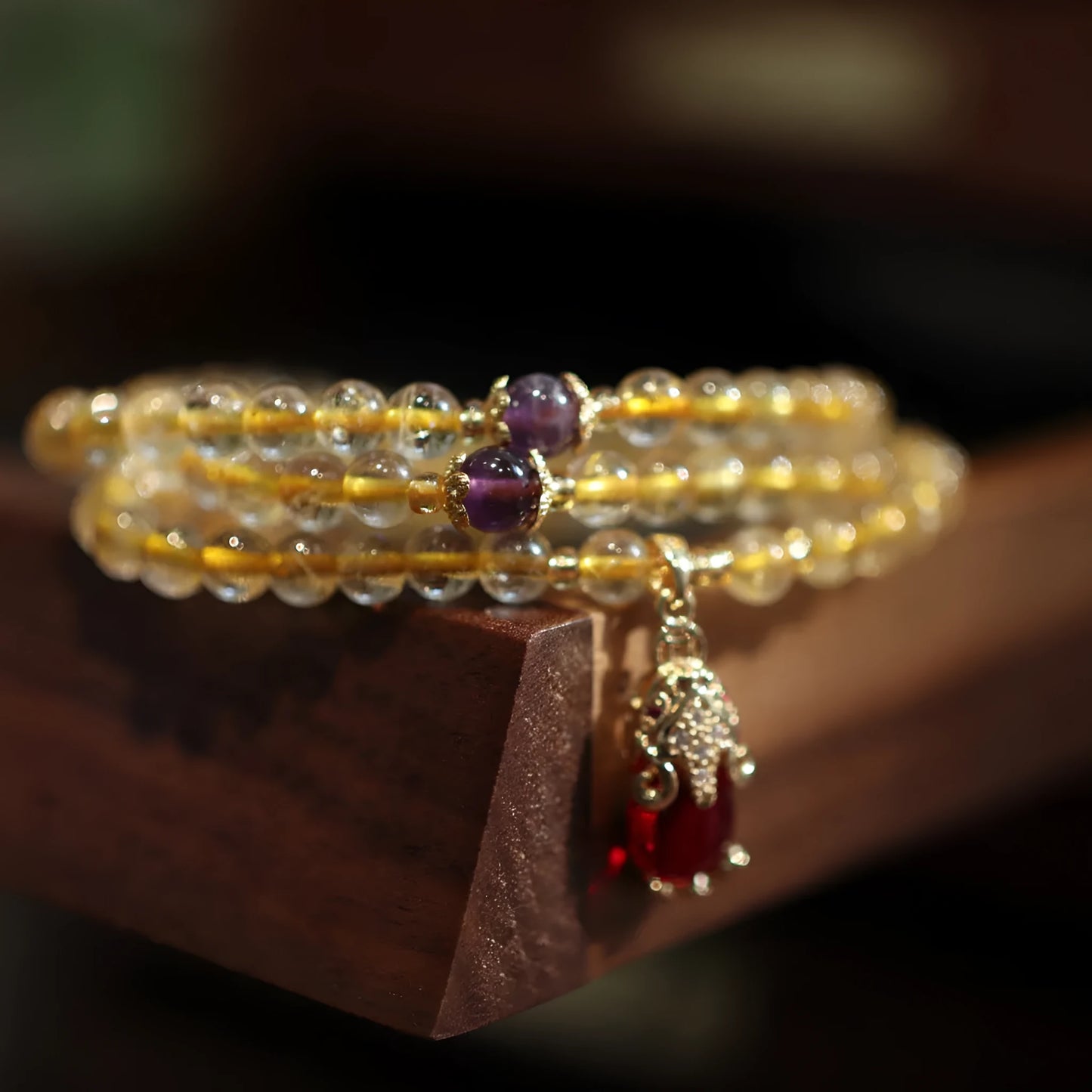 Natural gold rutilated quartz bracelet with Chinese style three circles and hanging chopsticks design.
