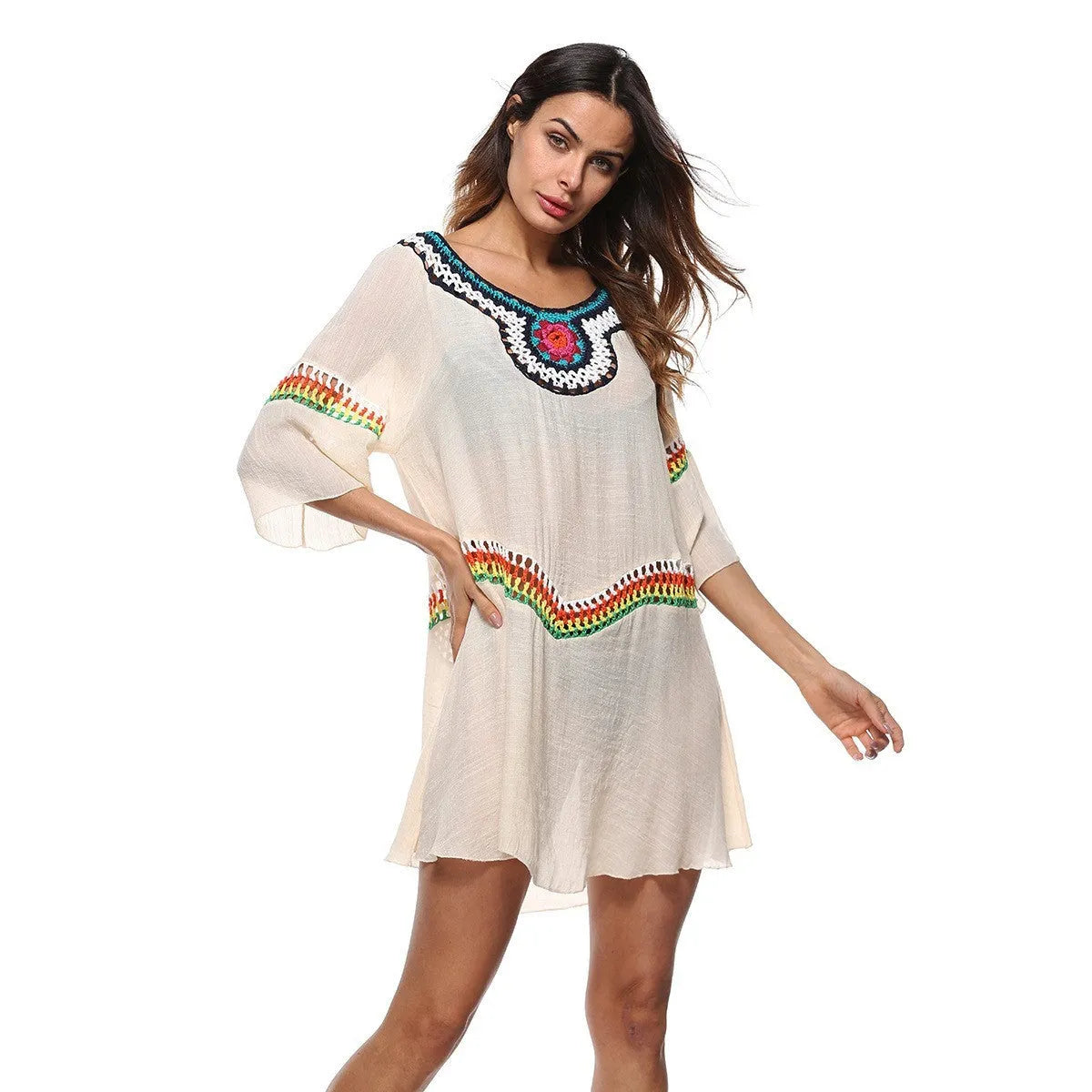 Crocheted white beach cover-up with open-knit design, worn over swimsuit, demonstrating UPF 50+ sun protection.