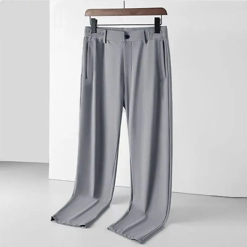 Man wearing black Ice Silk loose-fit casual trousers with an elastic waistband.