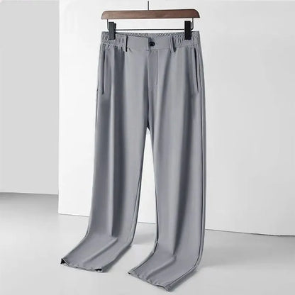 Man wearing black Ice Silk loose-fit casual trousers with an elastic waistband.
