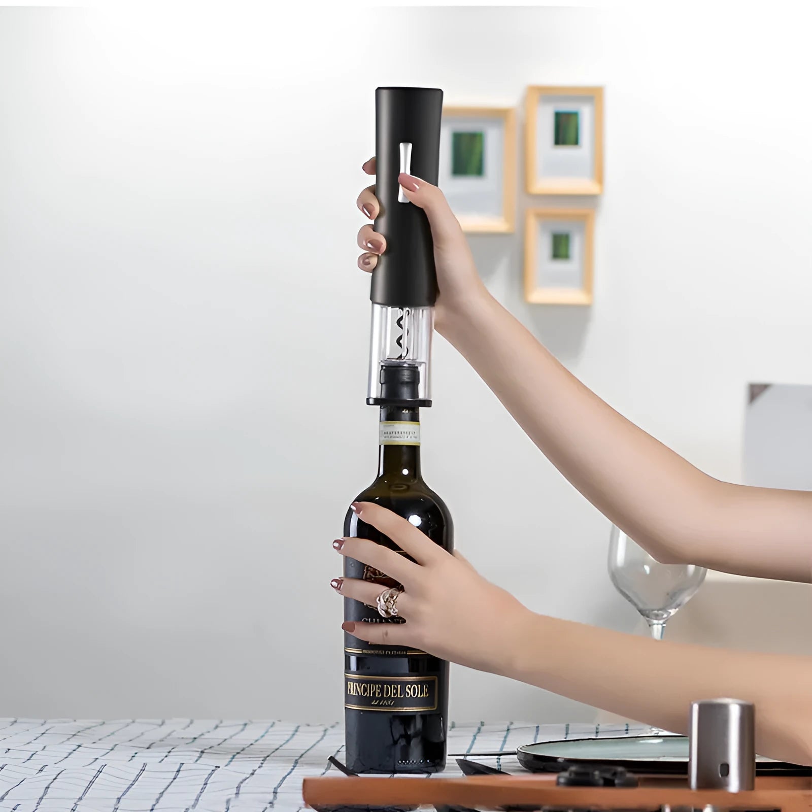 Black electric wine opener with transparent cover and aluminum foil cutter on wooden table