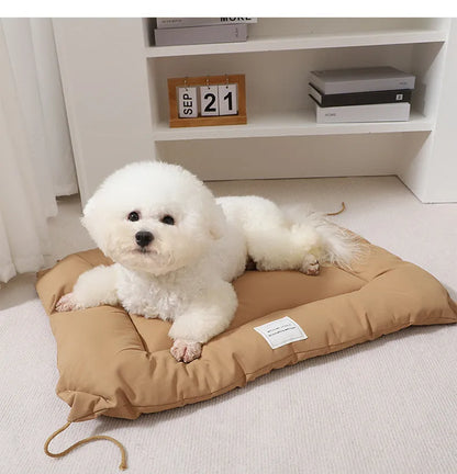 Beige cage cushion for dogs tied inside a metal crate, shown next to coffee and orange colour options.