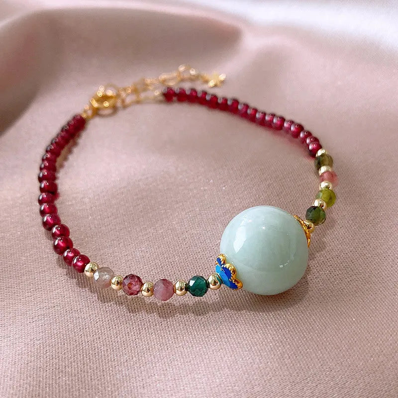 Women's garnet bracelet with aquamarine tourmaline drop charm and electroplated finish