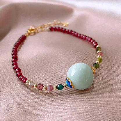 Women's garnet bracelet with aquamarine tourmaline drop charm and electroplated finish