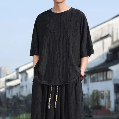 Men's thin knit two-piece suit with half-sleeve top and cropped trousers in black or grey colour options