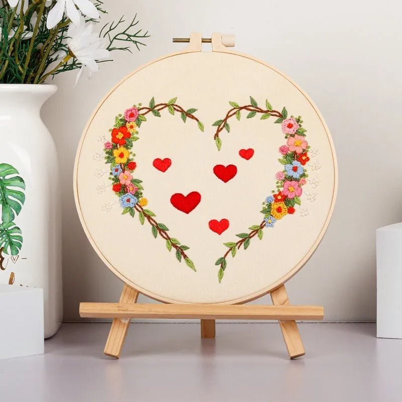 DIY Valentine's heart embroidery kit with cotton cloth and 20cm bamboo ring on a table.