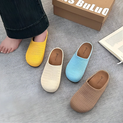 Baotou Boken women's cloth upper slippers with rubber sole in beige, shown in a leisure setting.