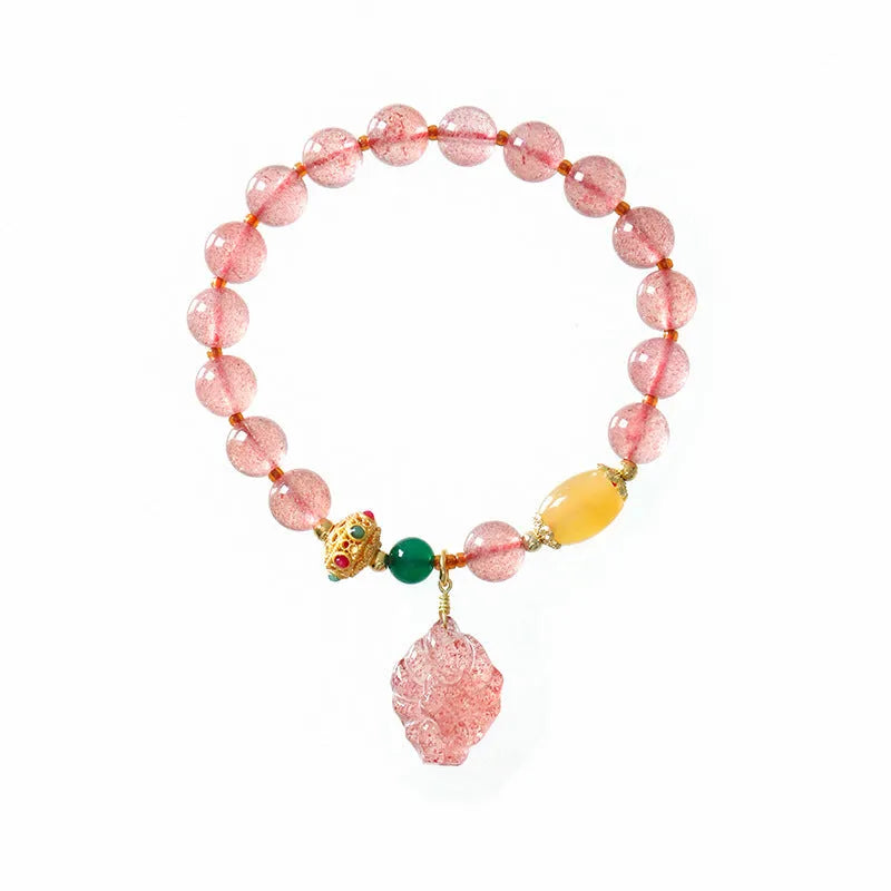 Women's strawberry quartz crystal beaded bracelet with Nine Tail Fox design on wrist