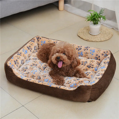 Beige plush pet bed for small dogs with a removable cover and non-slip base, shown in a home setting.