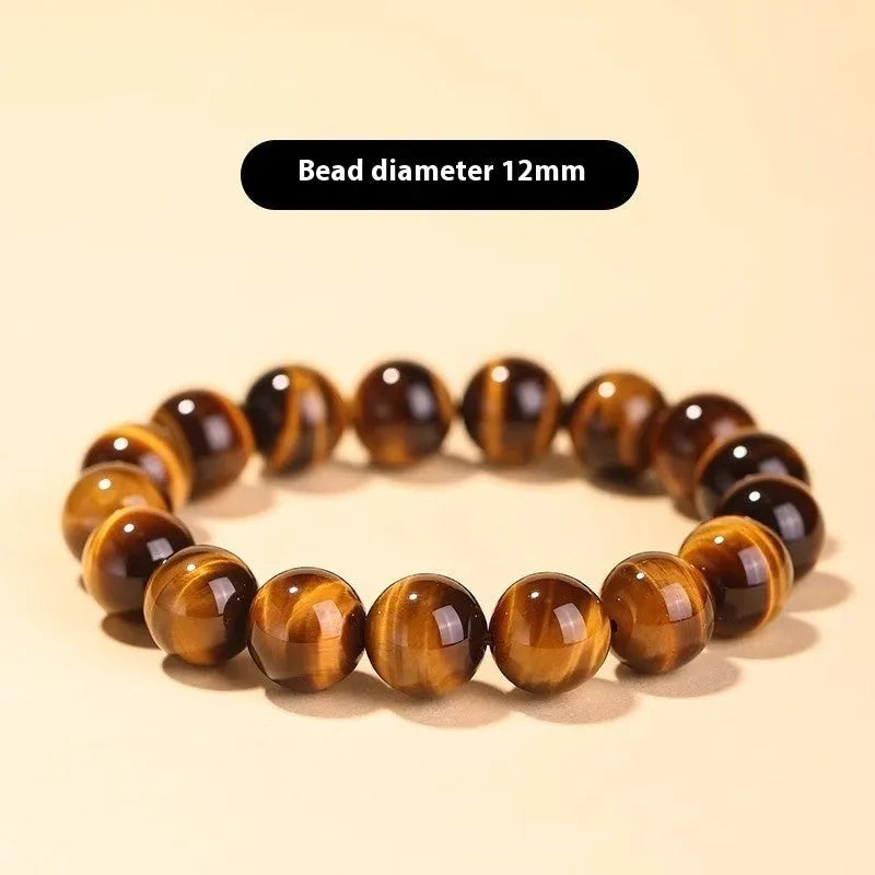 Tigereye dzi bead buddha bracelet with adjustable closure, shown in simple bracelet style.