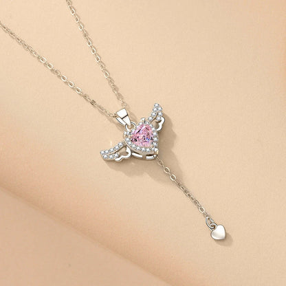 Elegant angel wings necklace with moving heart pendant, made of titanium steel and crystal accents