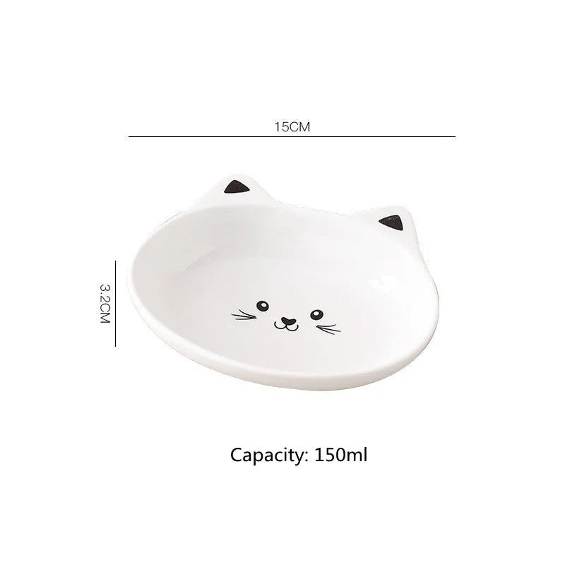 White ceramic pet food bowl with raised cat face design for cats and small dogs