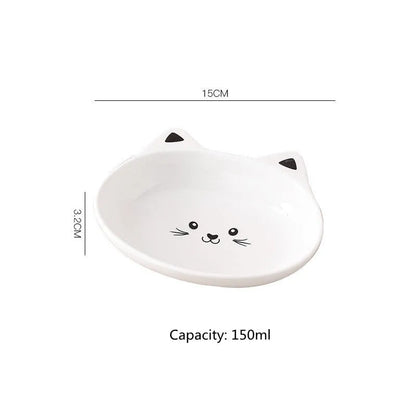 White ceramic pet food bowl with raised cat face design for cats and small dogs