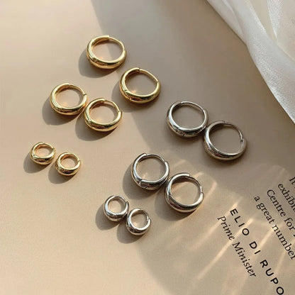 Women's minimalist geometric water drop earrings in gold and silver, shown in large, medium, and small sizes.