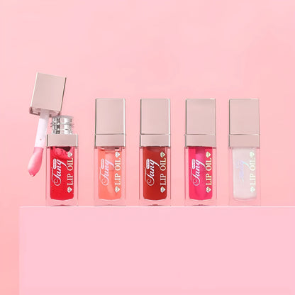 Set of five bright lip gloss tubes with lip essence oil applicators in shades Style001, 006, 007, 012, and 015.