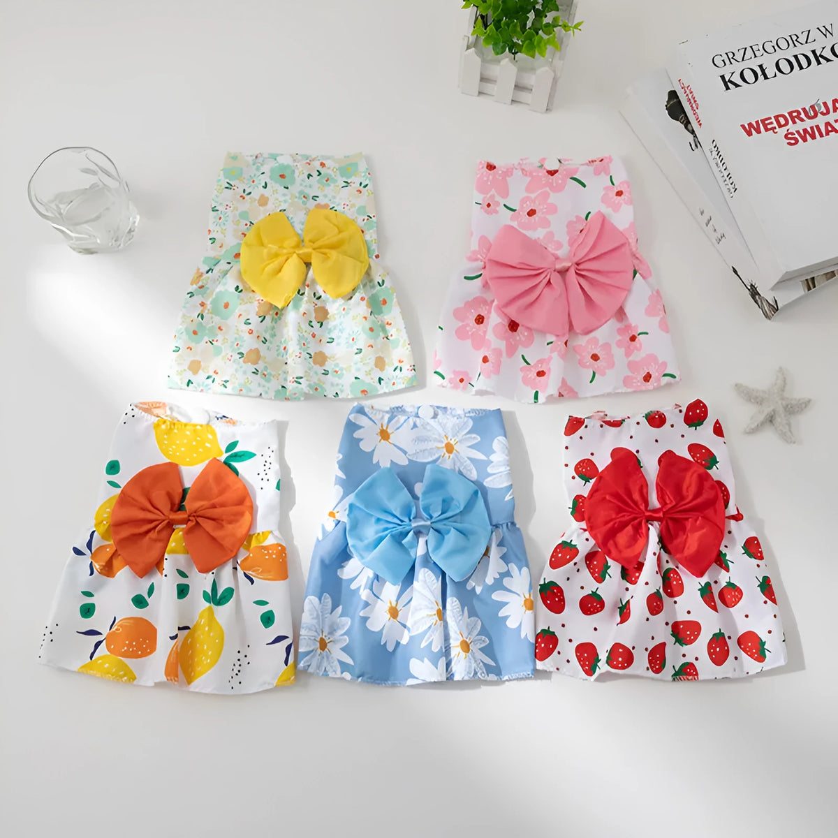 An orange floral butterfly knot princess dress for a small dog on a summer day.